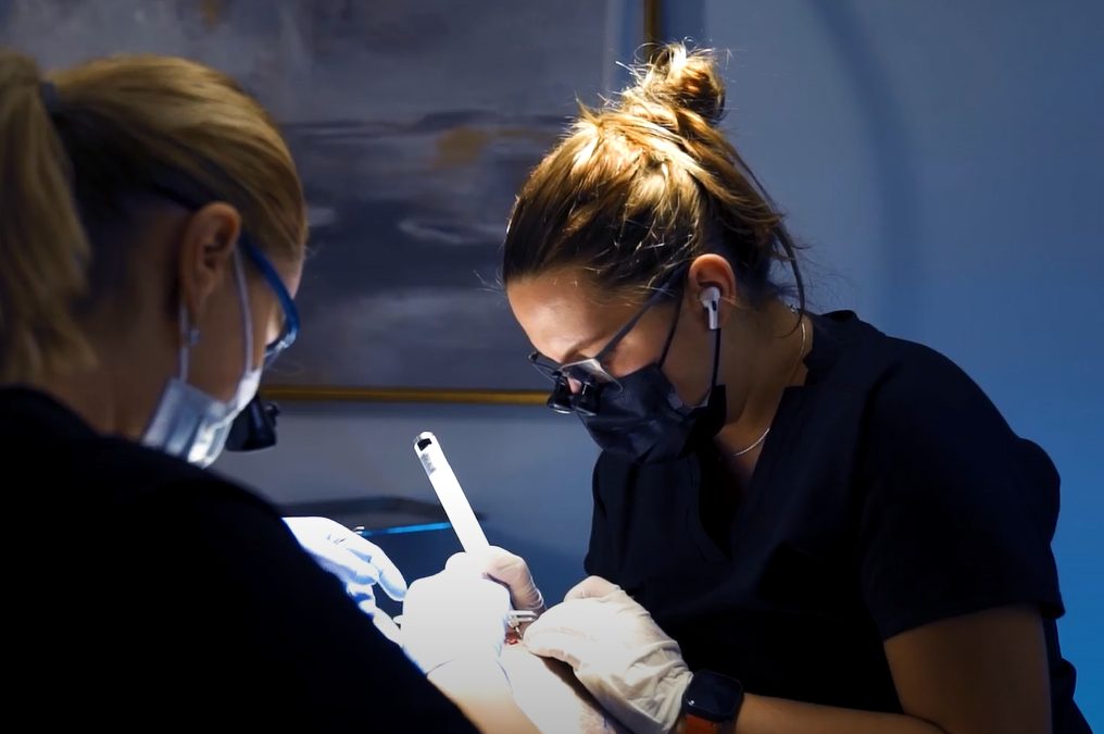 Two masked technicians working on a hair transplant patient at Nova Medical Hair Transplant Chicago